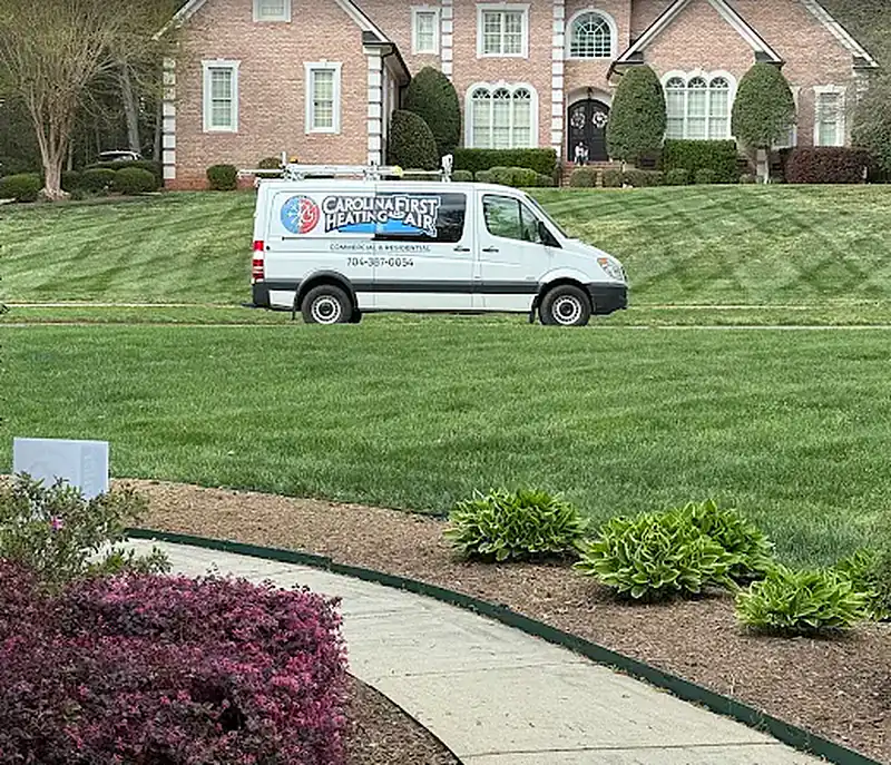 Carolina First Heating & Air service van at a home in the Charlotte area