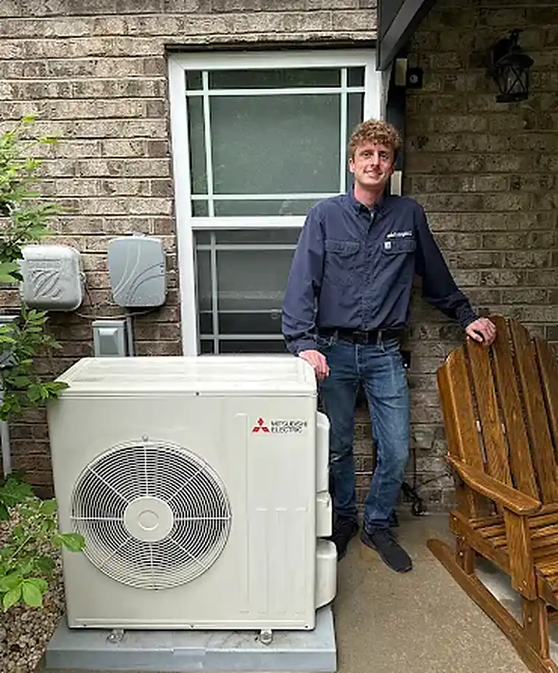 Wall-mounted Mitsubishi Electric ductless head and line set on an interior wall
